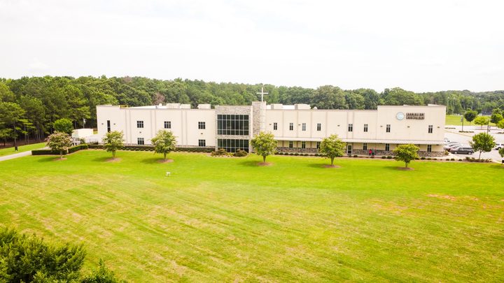 The image showcases a well-maintained lawn at the headquarters of Cornerstone Church Athens, providing a welcoming outdoor space for community gatherings and events. This green area serves as an inviting backdrop for church activities, fostering a sense of connection among members.